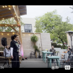 Outdoor stage with speaker holding a microphone